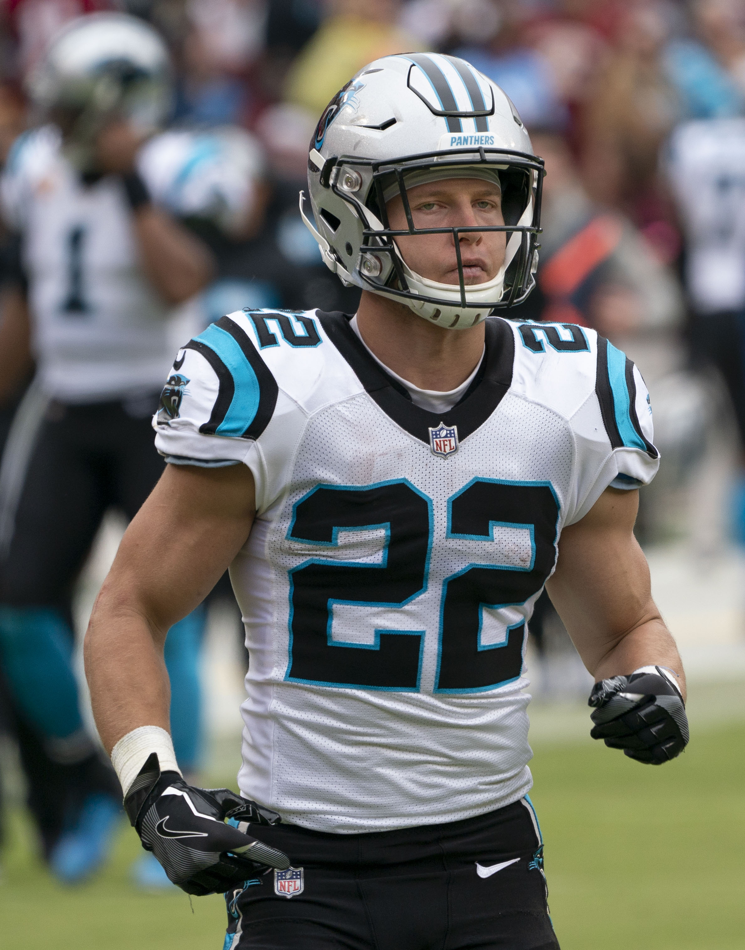 Christian McCaffrey carries the football for Carolina during a 2018 NFL game, illustrating the veteran workload Kaelon Black now complements in San Francisco.