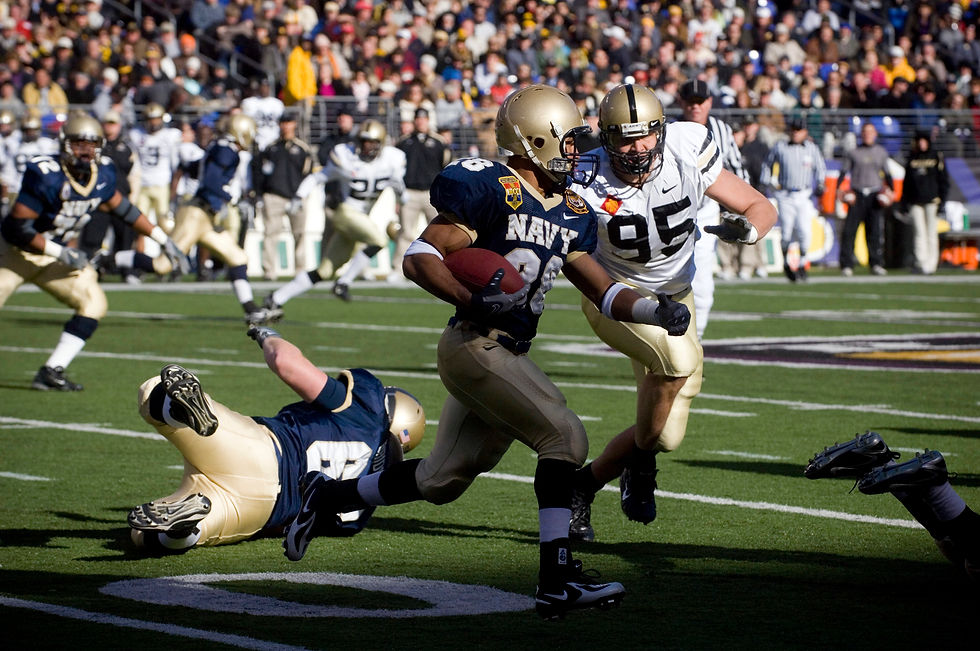 A Navy wide receiver turns upfield with the football after making a catch.