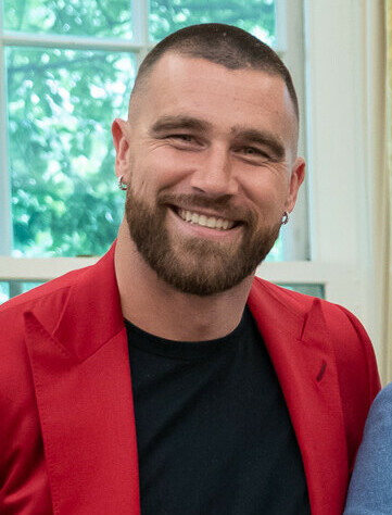 Travis Kelce wearing a dark suit in the Oval Office in June 2023