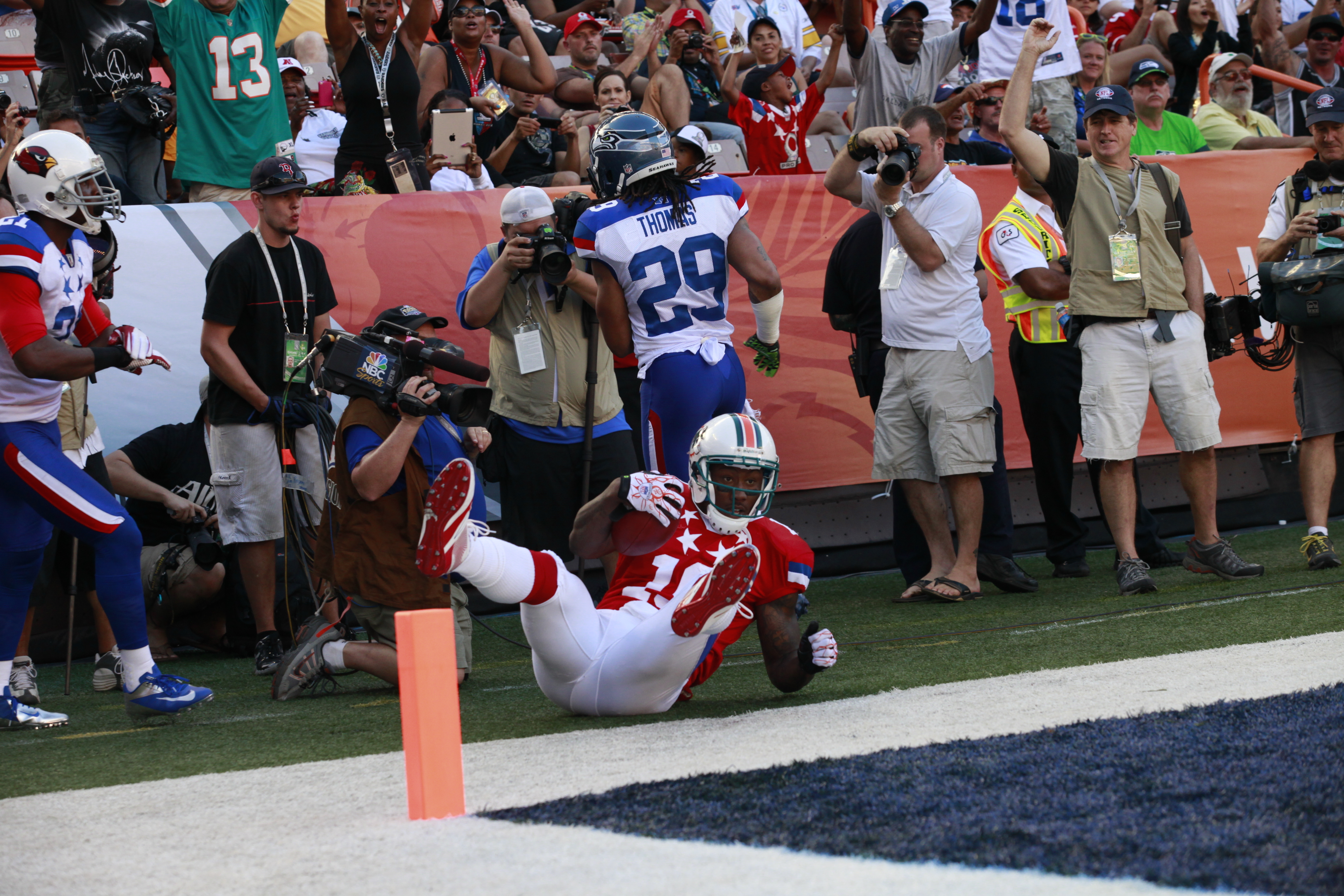 Brandon Marshall falls beyond the sideline after Earl Thomas pushes him out of bounds during the 2012 Pro Bowl.