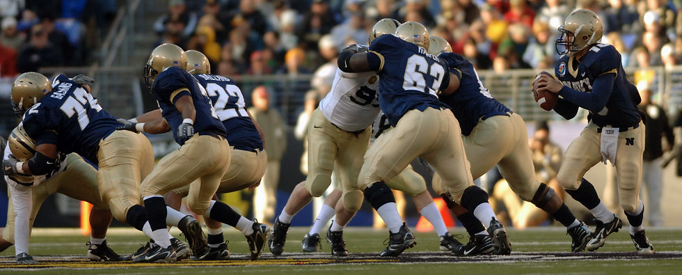 Navy quarterback drops back to pass behind five offensive linemen in pass protection during the 2007 Army-Navy game.