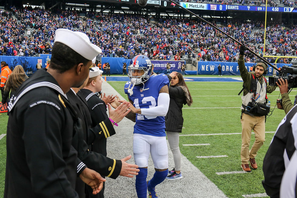 Odell Beckham Jr. greets United States military members before a New York Giants game at MetLife Stadium in November 2018.