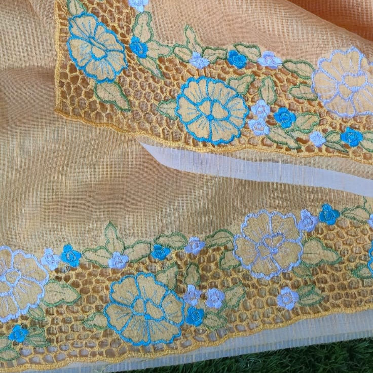 Thumbnail: Blouse sleeves of orange Kota saree featuring intricate cutwork