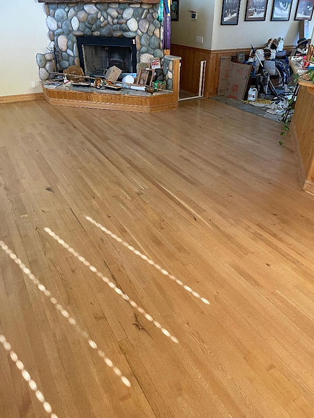 Remodeling project showing a deep wood floor restoration and surface prep on classic wood planks to repair scratches and wear