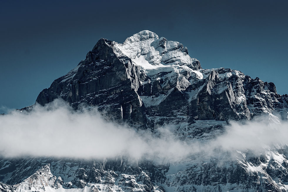 beautiful-shot-snowy-mountains-surrounded-by-clouds.jpg