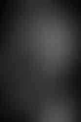 a shirtless man with a tattoo on his shoulder is using a weight machine