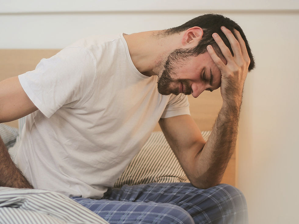 A man is sitting with stomach pain