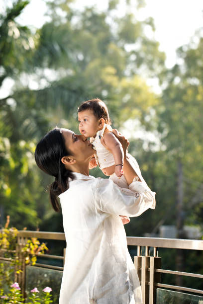 Mother holding baby with joy