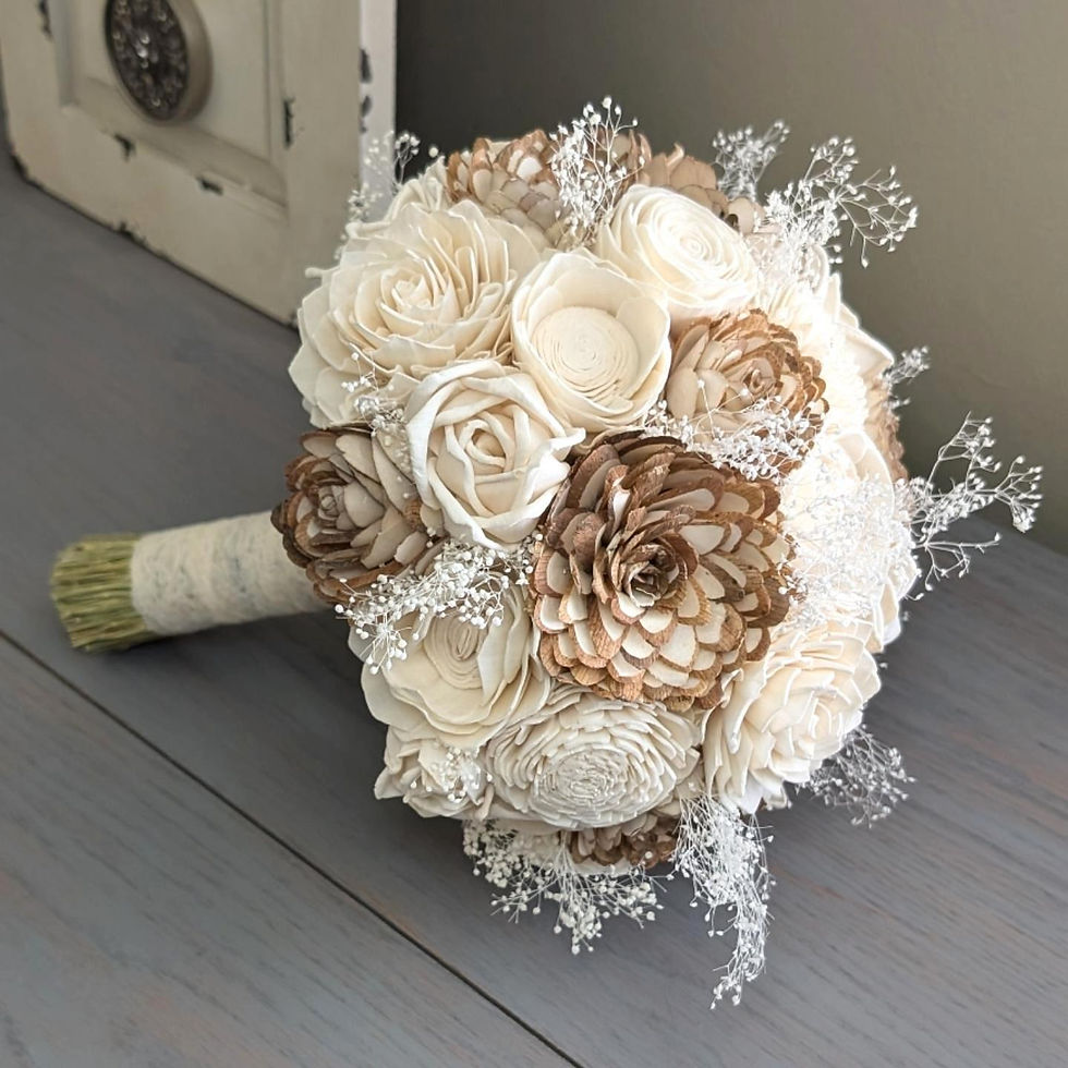 Sola Wood Wedding bouquet of cream and tan wooden flowers with white accents on a gray table, set against a muted background, evoking elegance and simplicity.