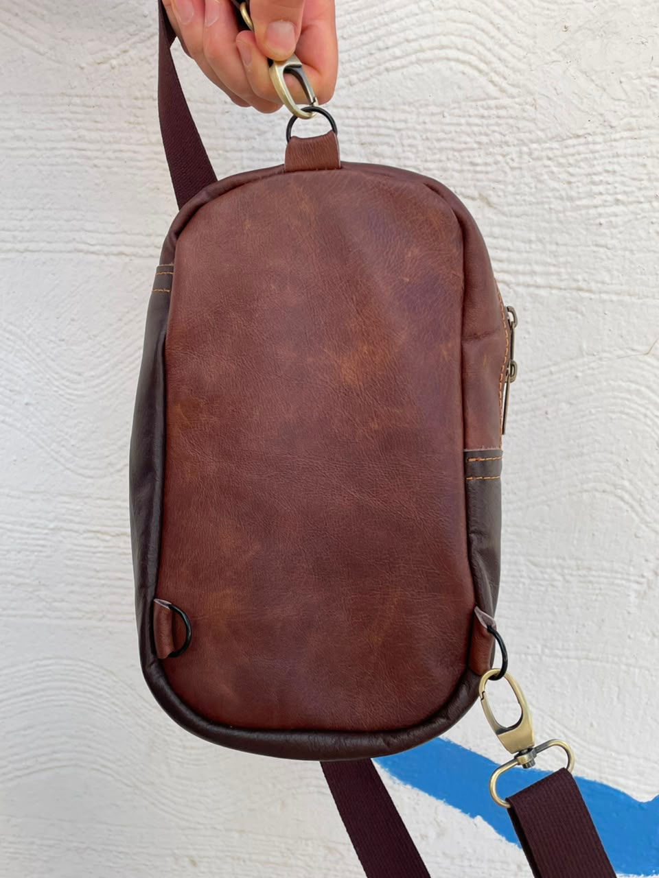 Μικρογραφία: Back view of handmade leather sling bag with adjustable strap, crafted in Crete Greece