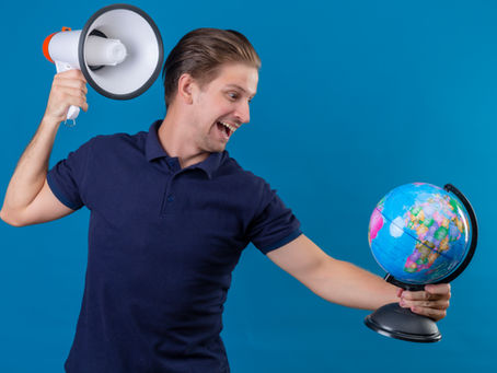 Man holding a megaphone and a globe, representing global agricultural marketing and the power of transcreation to reach international audiences.
