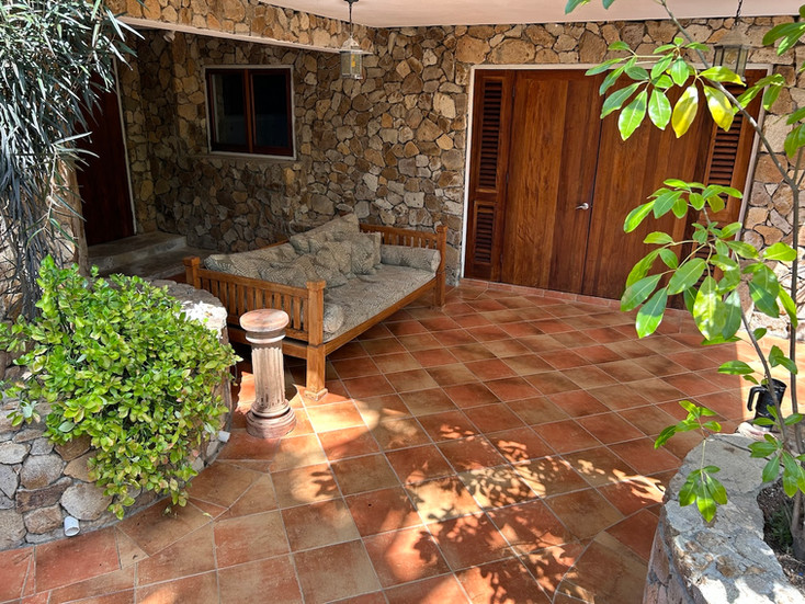 Garden apartment entrance with seating area