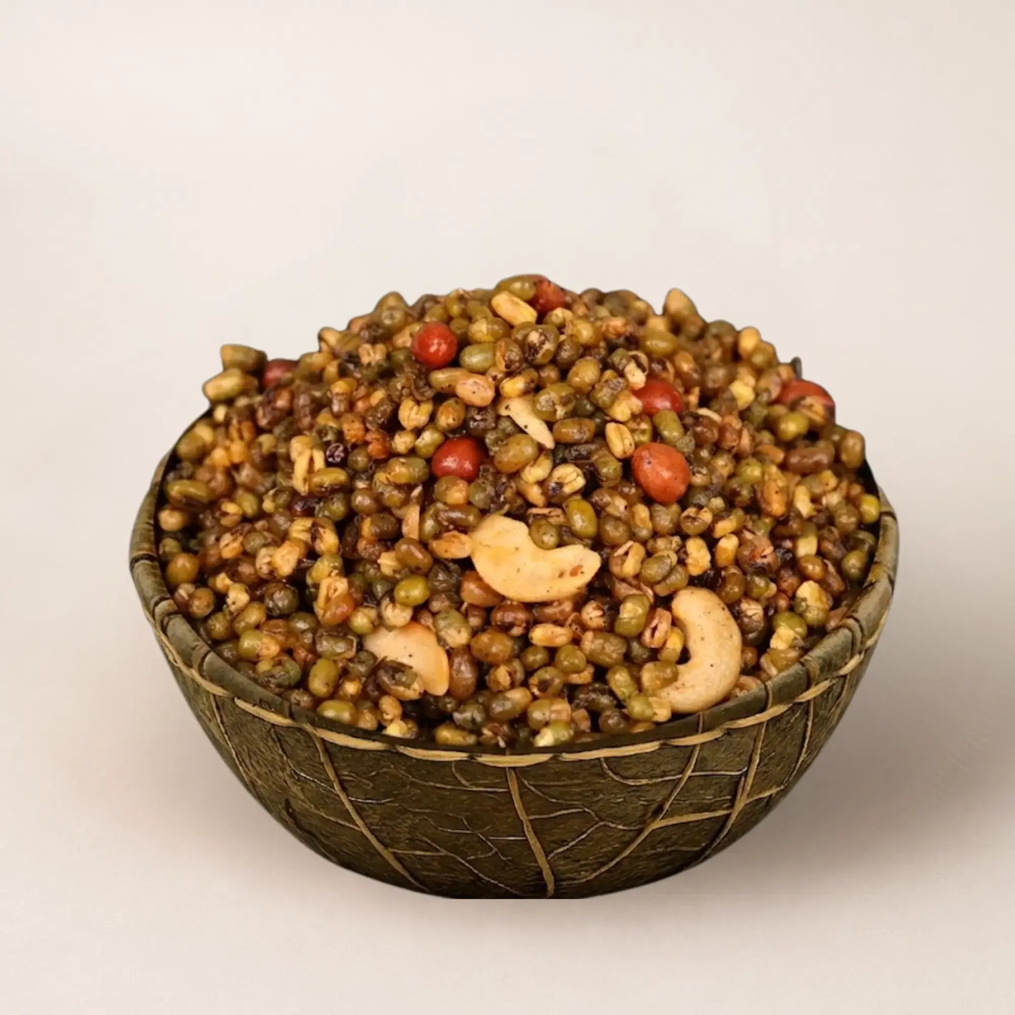 Bowl of green gram masala with cashews and peanuts.