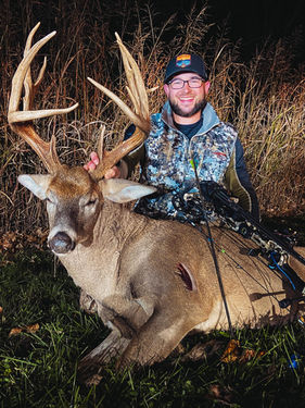 customer with whitetail deer after successful hunt