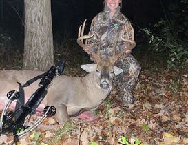 customer with whitetail deer after successful hunt