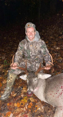 customer with whitetail deer after successful hunt