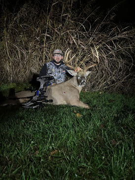 customer with whitetail deer after successful hunt