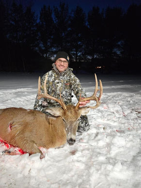 customer with whitetail deer after successful hunt