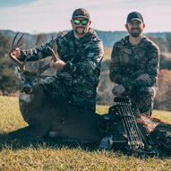 customer with whitetail deer after successful hunt