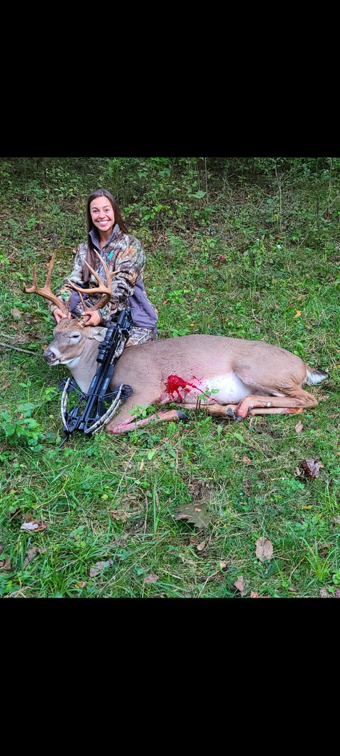 customer with whitetail deer after successful hunt