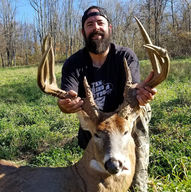 customer with whitetail deer after successful hunt