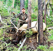 customer with elk after successful hunt