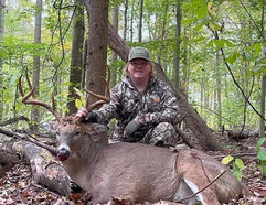 customer with whitetail deer after successful hunt