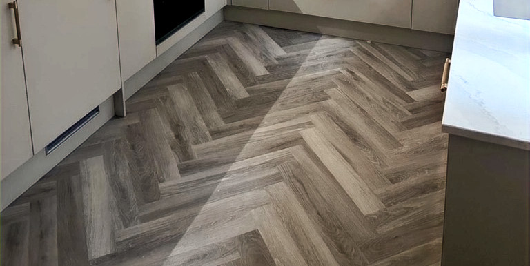 Modern kitchen featuring Lvt and wooden flooring in Soho W1