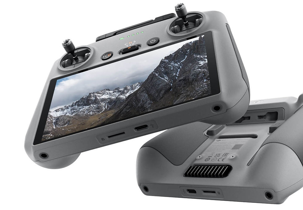 Drone remote controller with screen showing snowy mountains