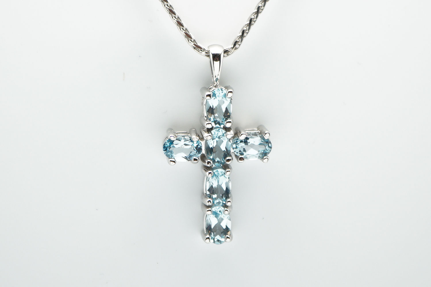 14 karat white gold blue topaz cross pendant