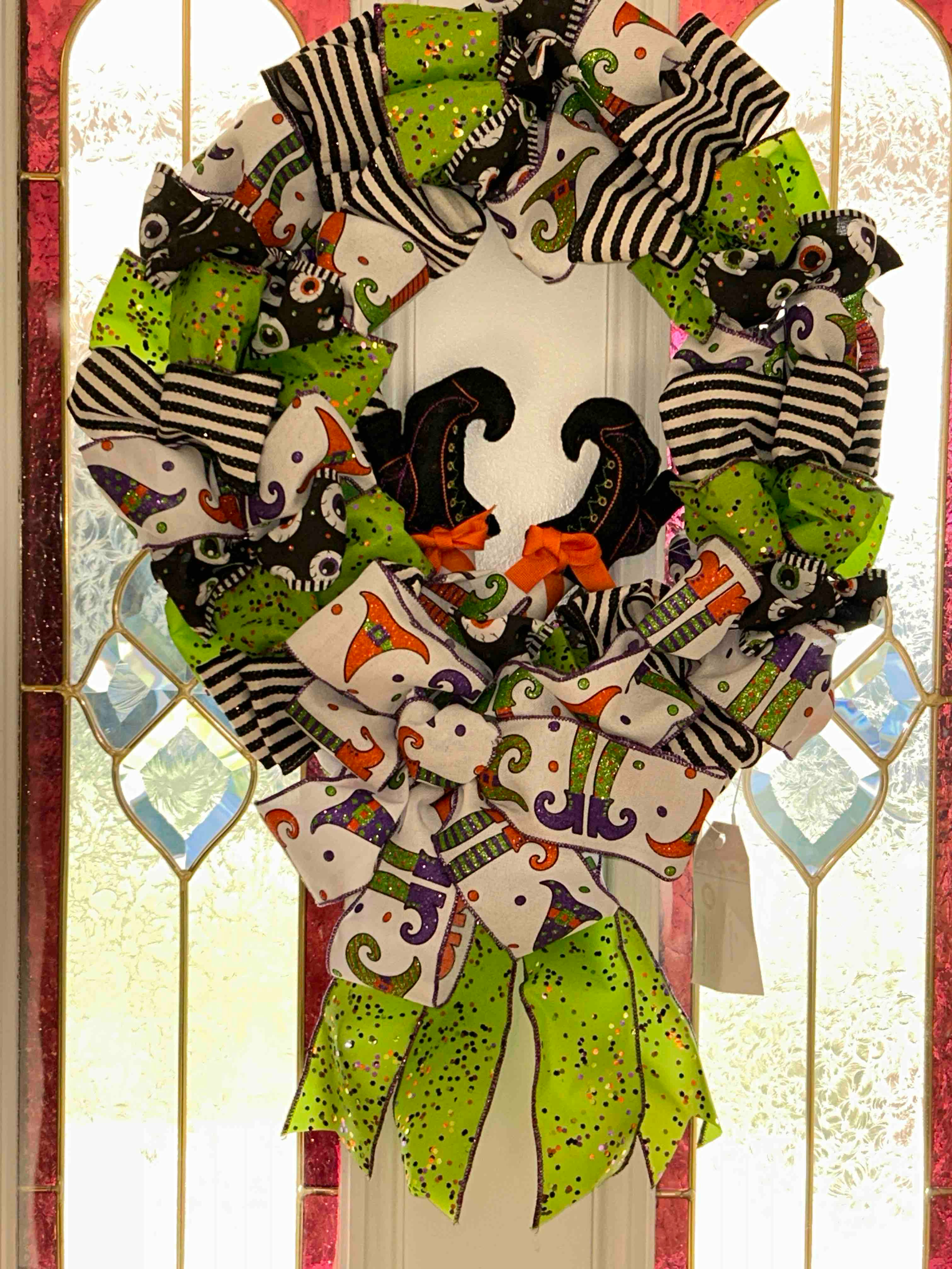 Mix of vibrant, high-quality ribbons in classic Halloween colors door wreath.