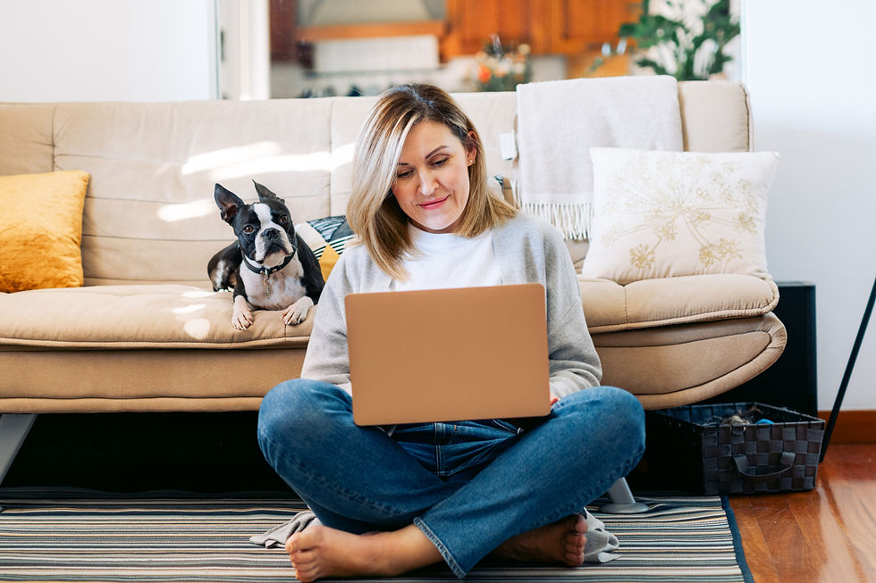 Cis female client sitting on a living room floor with a computer on her lap