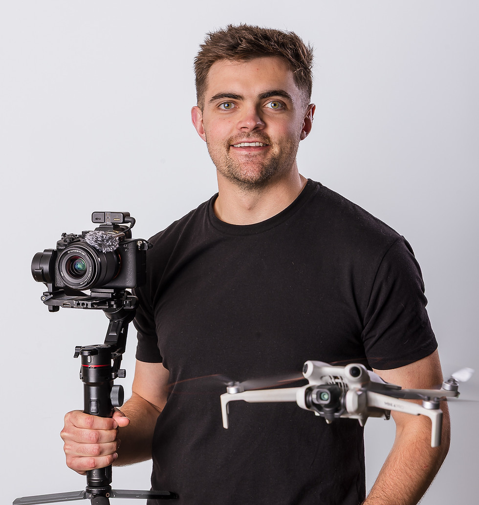 Professional headshot photography of a man with camera gear