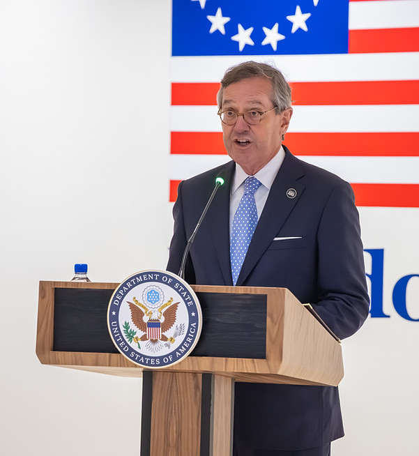 Commercial photography techniques for event photography of a speaker at the U.S. Department of State podium.