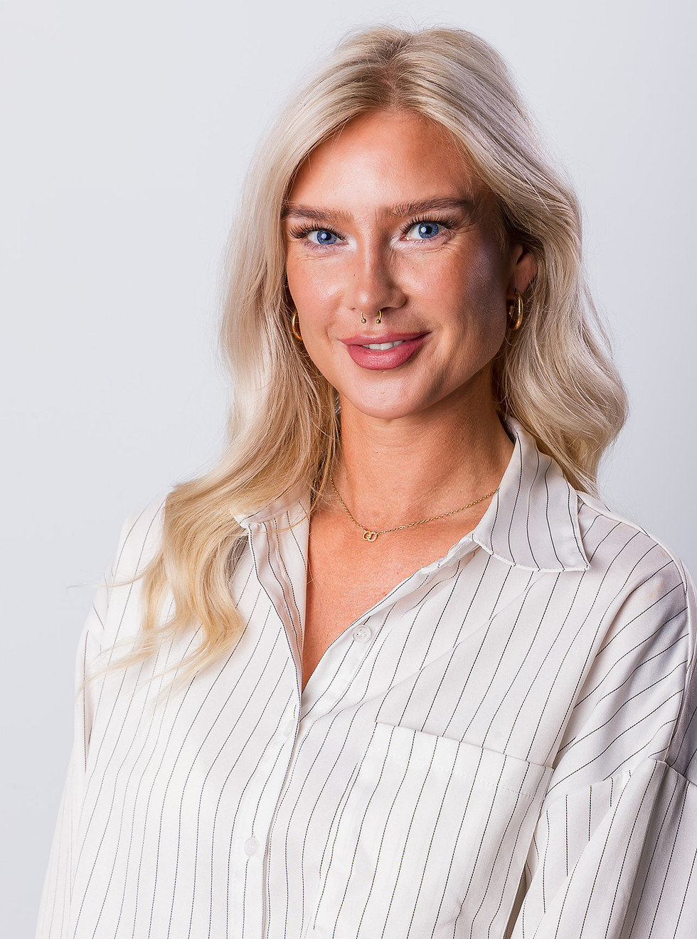 Blonde woman in striped shirt professional headshot photography