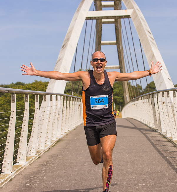 Runner celebrating on a bridge in sports and action photography
