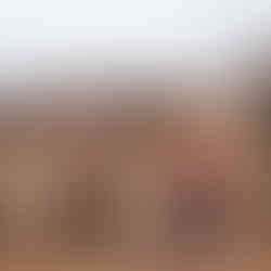 Two musicians playing a bagpipe and a box drum