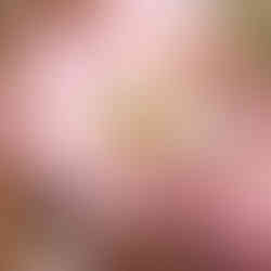 Someone serving lasagna to a person sitting at a table