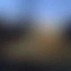 A family poses in front of a photo op that is designed to look like a living room