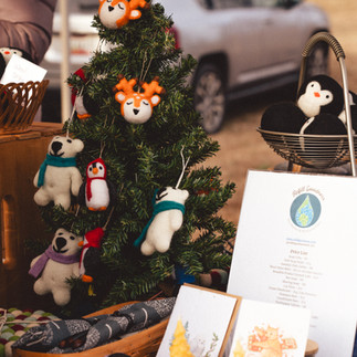 Various signs, candles, and a small Christmas tree on a table