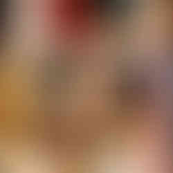 Candle sticks in the foreground frame a arm outstretched placing a linen wrapped present on a shelf.