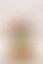 Rustic wooden nesting shelves staggered with a jar of pink tulips sitting atop adding a nice spring touch