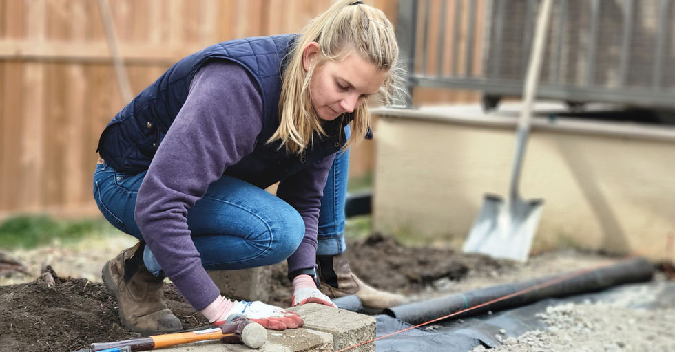 Calgary Lawn Solutions team member building a retaining wall