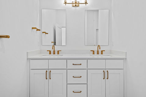 Sutton Cottage Home Bathroom with double sink, quartz countertops and Moen Finishes. Luxury Builder in NWA. 