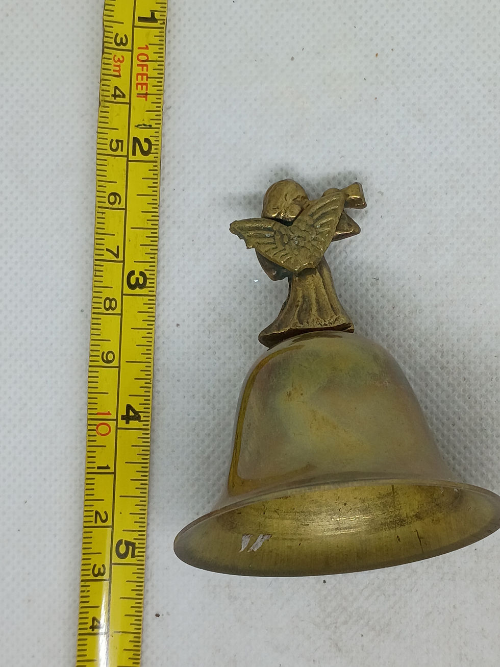 Thumbnail: 3" tall vintage brass figural bell featuring an Angel blowing a trumpet
