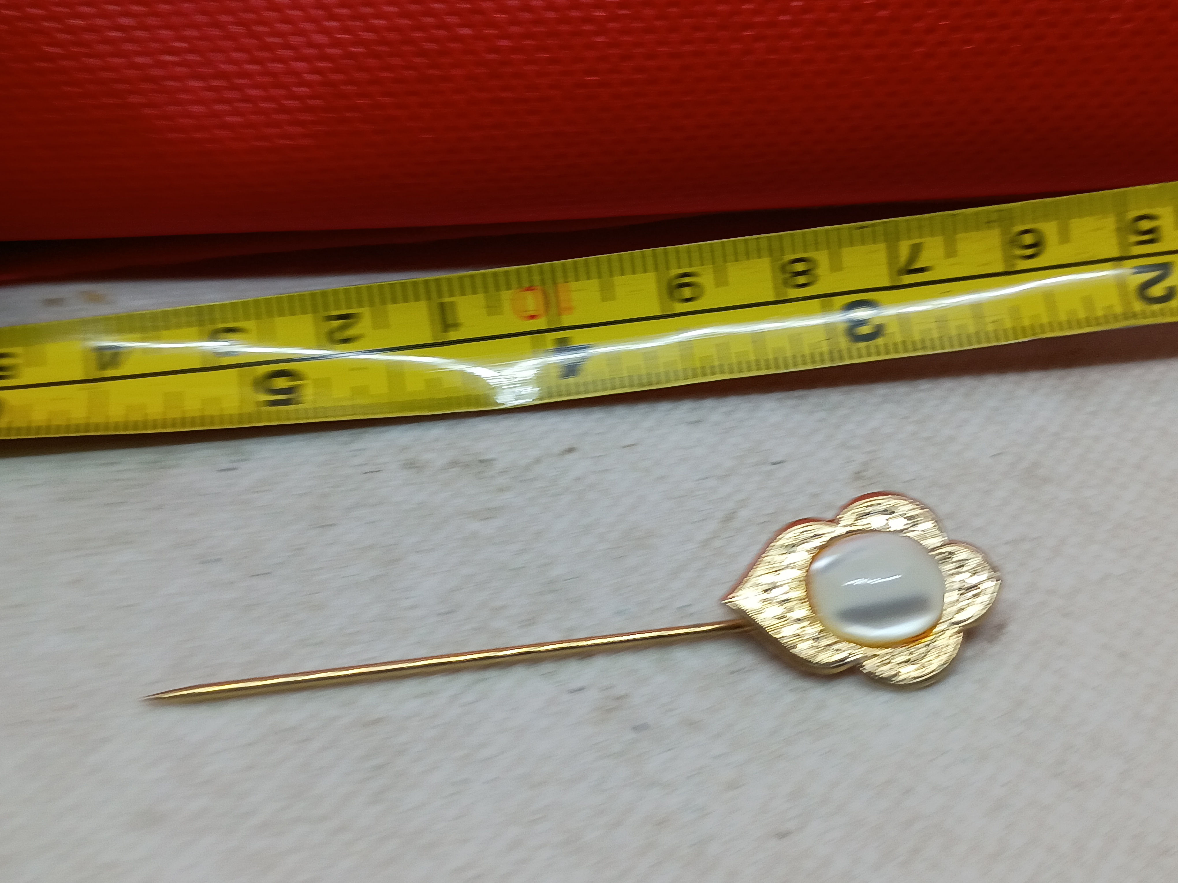 3.25" Vintage gold-tone stick pin featuring an oval iridescent cabochon stone