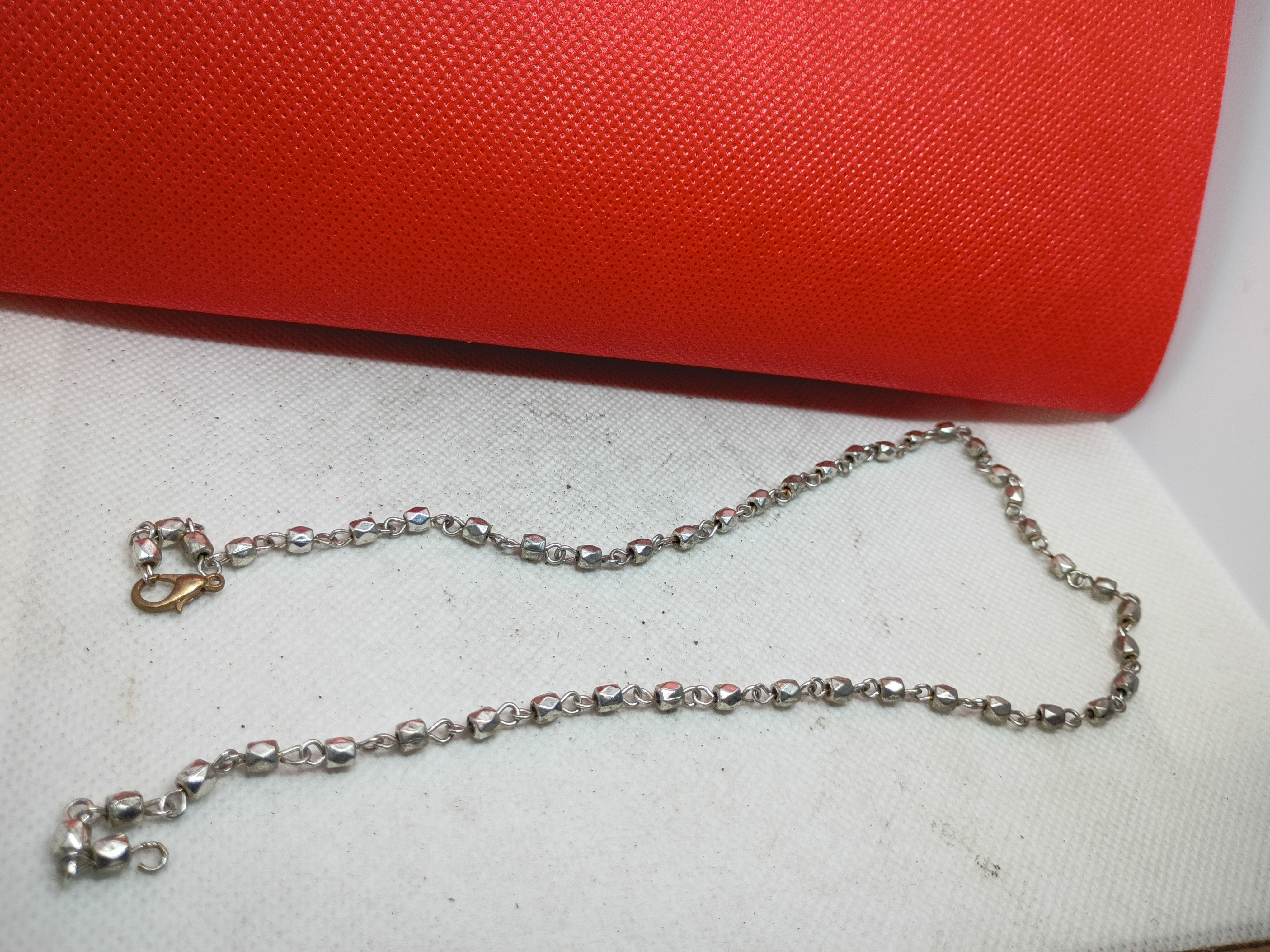 Approx 18" a silver-toned faceted bead or moon-cut chain necklace