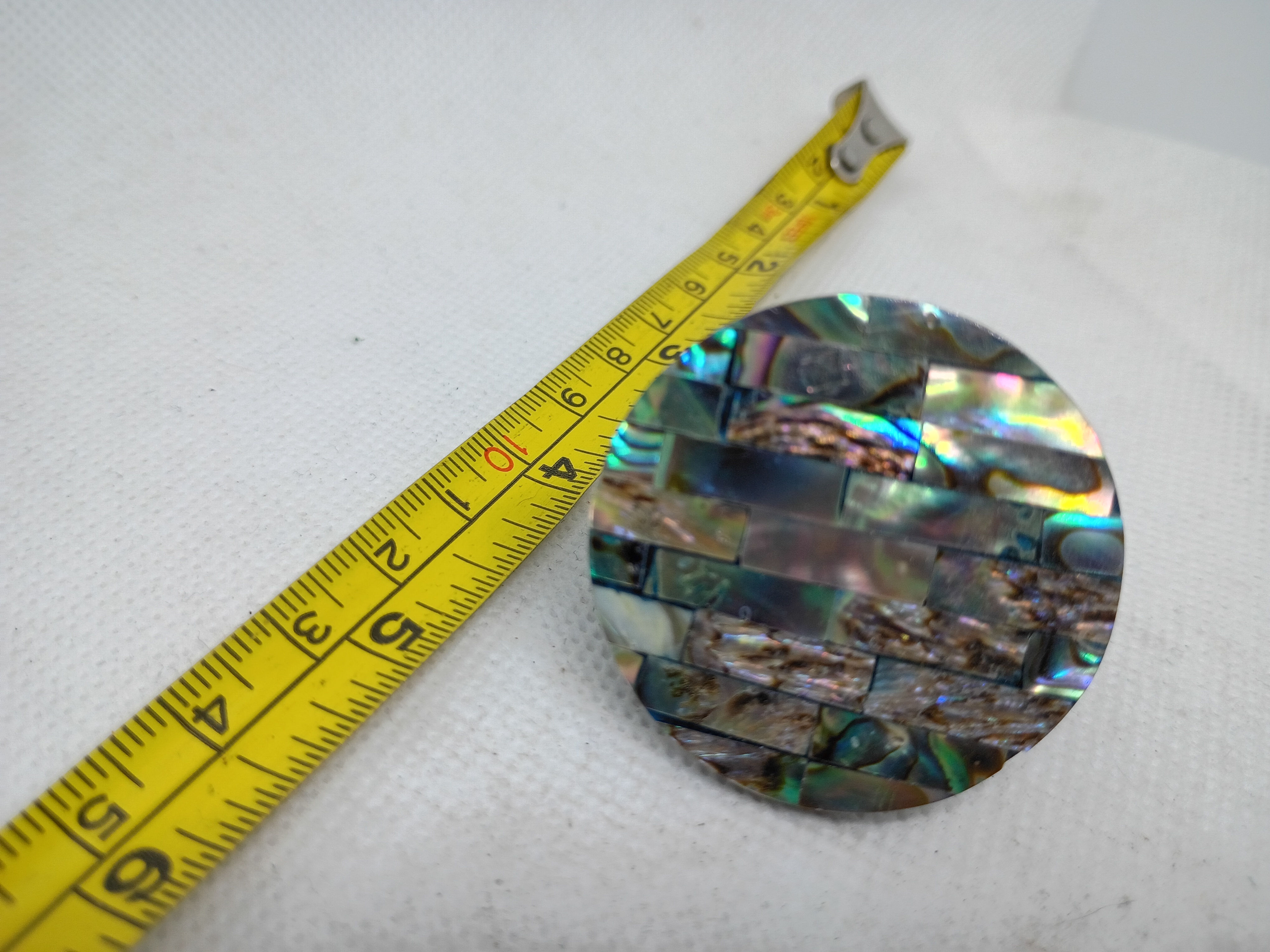 Abalone shell mosaic ring- iridescent inlay on a dark hard plastic or resin band