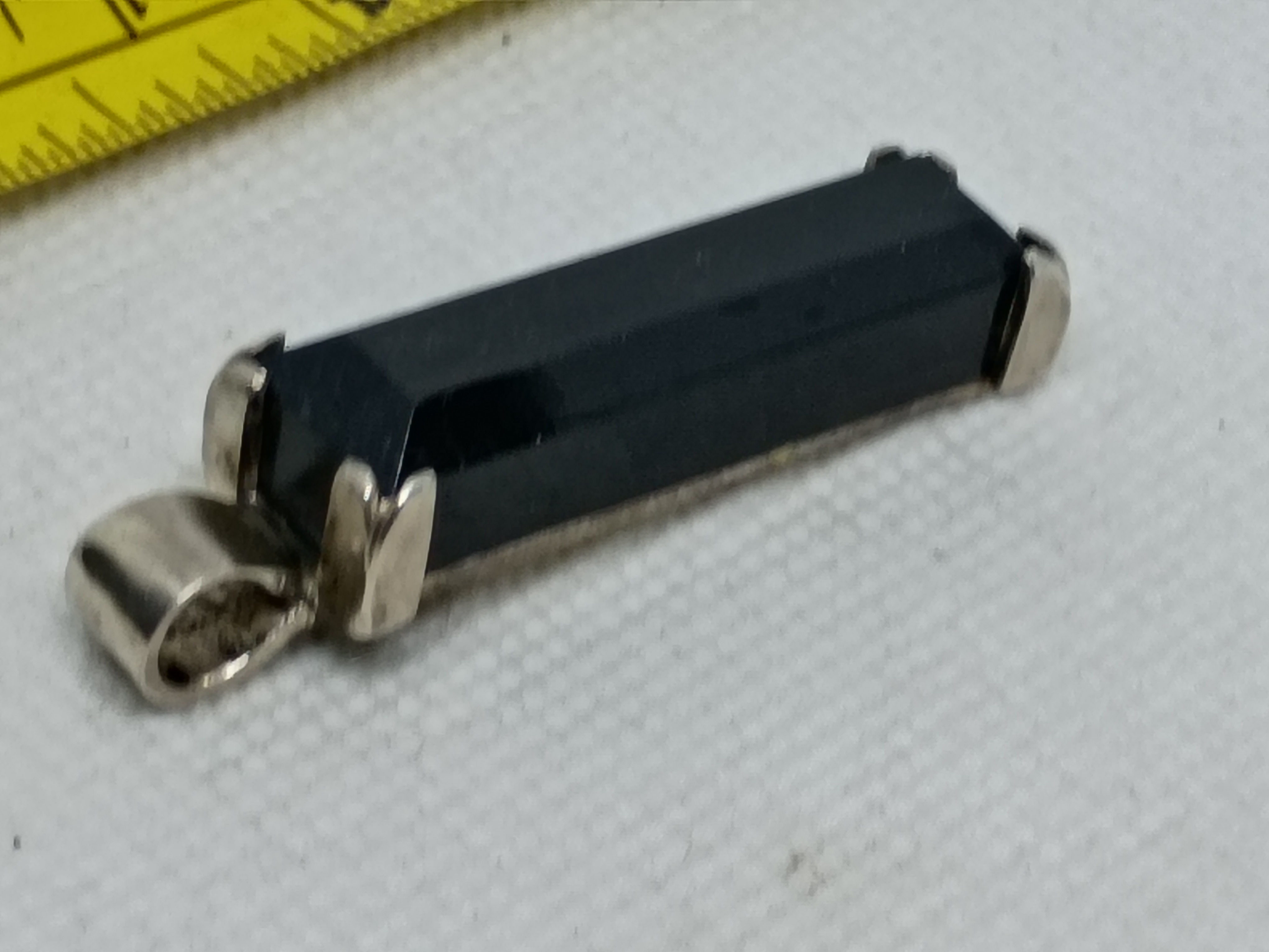Approx. 1.5" Sterling silver pendant features a rectangular black onyx inlay