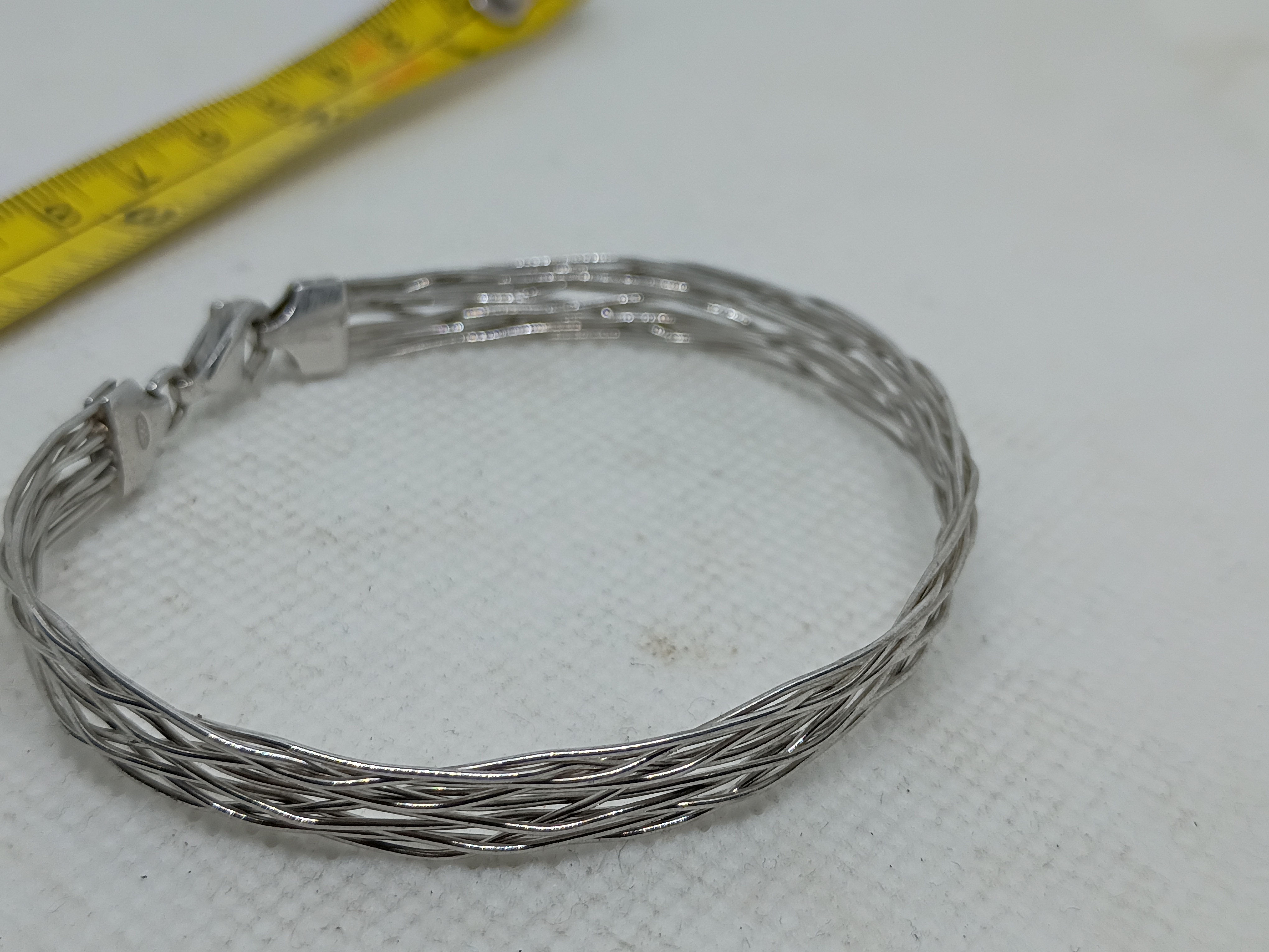 Approx.2.5" 925 sterling silver Italian braided bracelet features a woven design